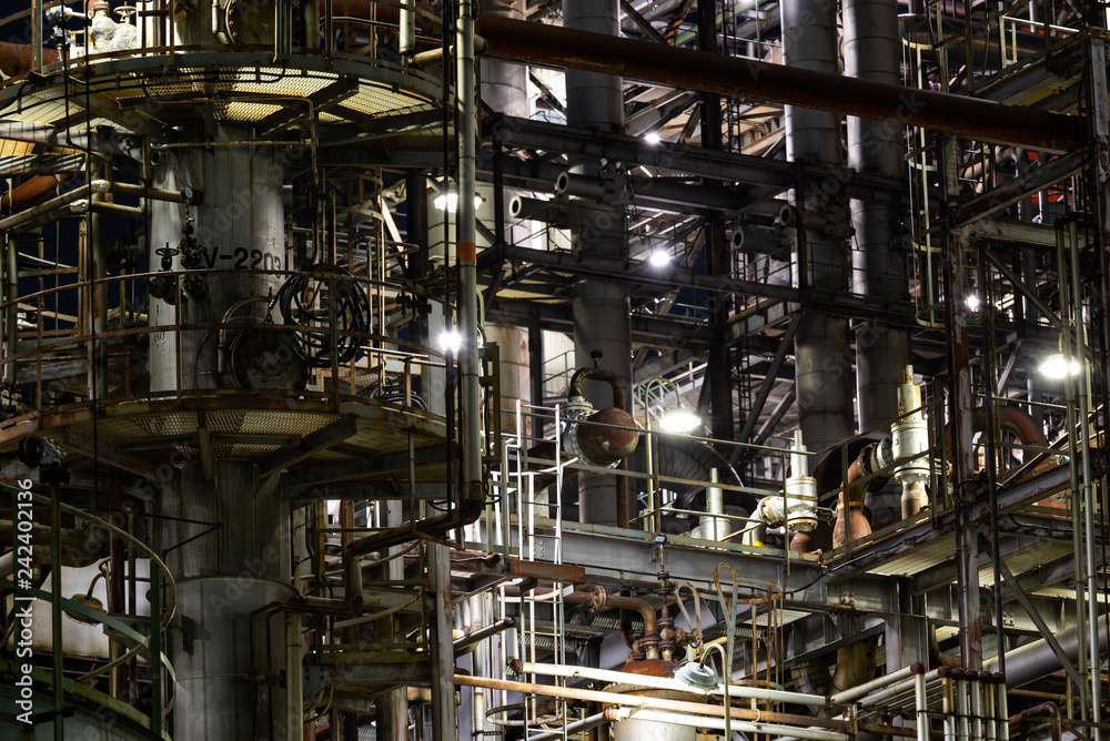 Column tower in petrochemical plant at night