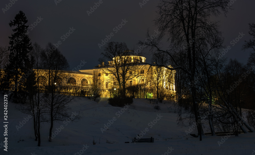 View of the Pavlovsk Imperial Palace. The palace is illuminated by spotlights. Winter is a lot of snow. Night photo. Pavlovsk, St. Petersburg, Russia