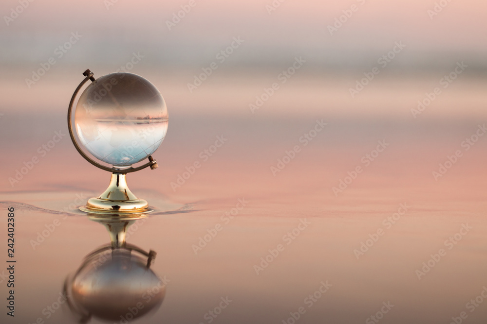 Glass Globe reflection on a sea shore Glass Globe reflection on a sea shore