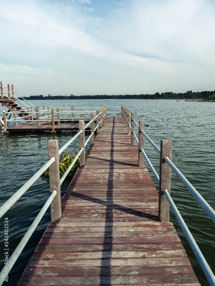 Long wooden bridge to big pavilion over the lake at Huay Mai Tai, Hua Hin, Thailand.