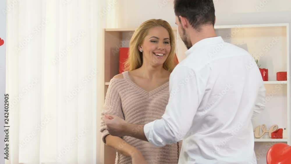 Couple in love dancing, celebrating Valentines day at home, romantic atmosphere Couple in love dancing, celebrating Valentines day at home, romantic atmosphere