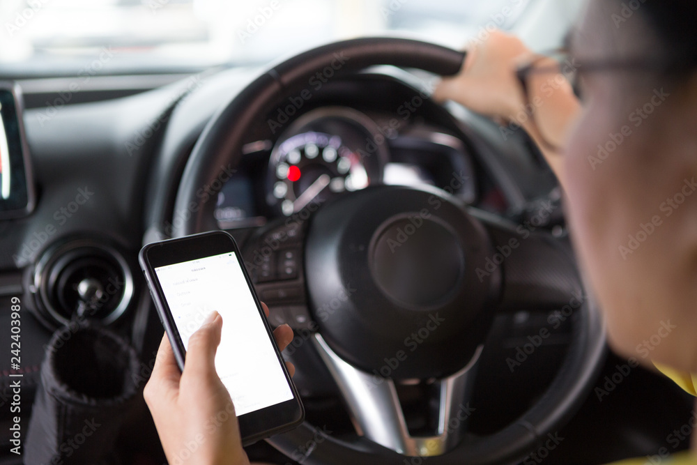 Women are using a mobile phone while driving
