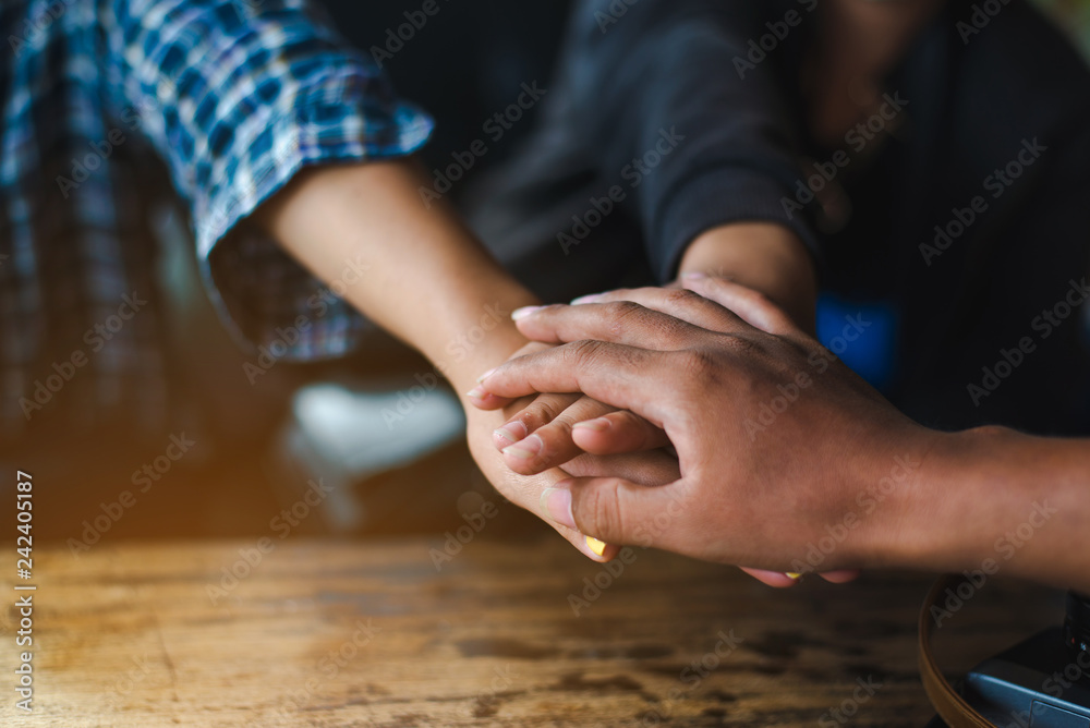 Business partnership of people holding hands together while working teamwork ,Close up of three  hand gesture, symbol of common celebration or greeting. Success and teamwork concept,copy space