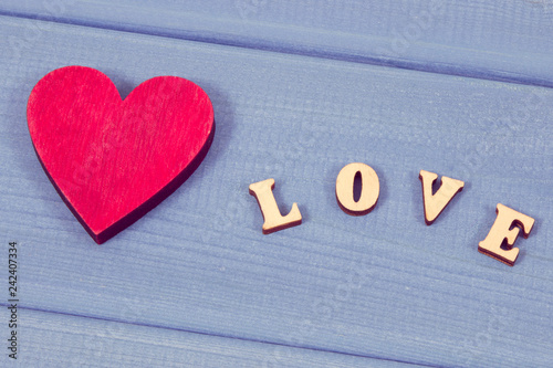 Word love and red heart, concept of symbol for Valentines Day. Vintage photo