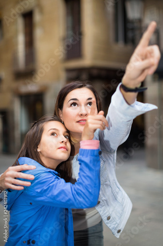 Young mother and daughter paying attention to sight photo