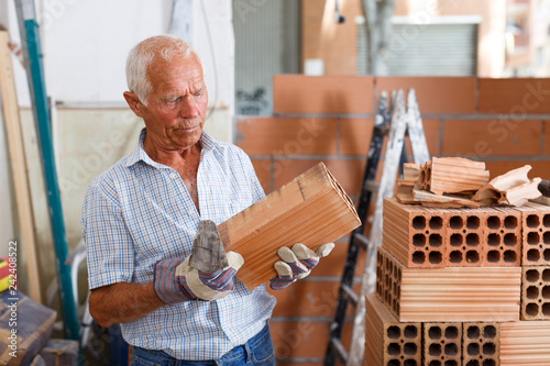 Man working with red brick