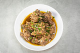 Chinese braised pork spare ribs with pepper and garlic sauce in white plate on the table
