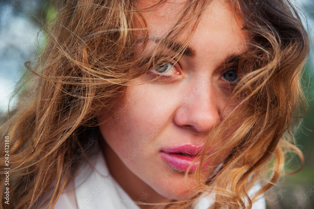Portrait of beautiful young European woman in summer park. Close-up Portrait of beautiful young European woman in summer park. Close-up