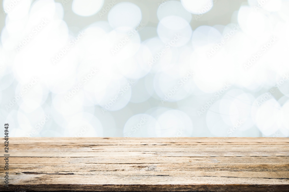 Fototapeta premium Wooden table with bokeh abstract background.