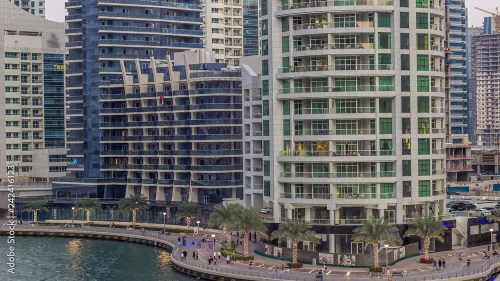 Luxury Dubai Marina canal with passing boats and promenade day to night timelapse, Dubai, United Arab Emirates Luxury Dubai Marina canal with passing boats and promenade day to night timelapse, Dubai, United Arab Emirates