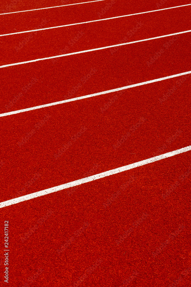 Red treadmill with white line at the stadium.