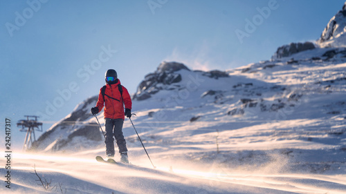 Skier on the mountain in a strong wind