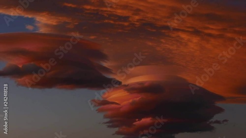 Time lapse of lenticular clouds at sunset photo