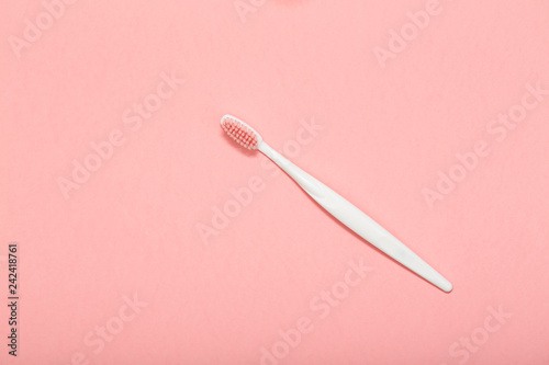 Toothbrush on pink background.