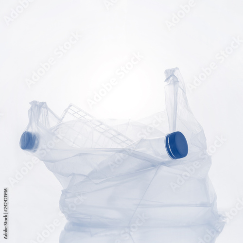 Various plastic garbage on the light background