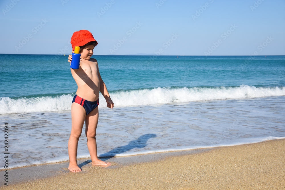 Sun protection concept - little boy with sun cream at beach Sun protection concept - little boy with sun cream at beach