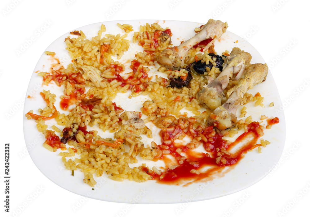 Fotografie Eaten scraps for homemade chicken and vegetable pilaf on a white plate isolated