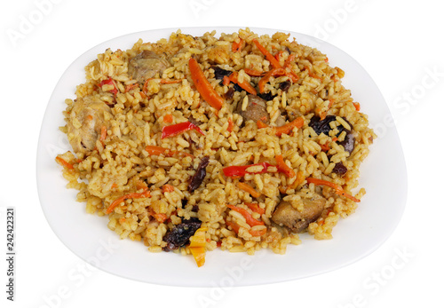 Homemade homemade chicken and vegetable pilaf on a white plate isolated