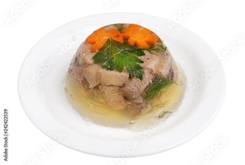 Homemade meat jelly from beef tongue with vegetables on a plate isolated