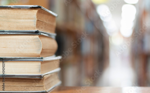 Book stack in library study room with bookshelf for business and education background, class learning and back to school concept