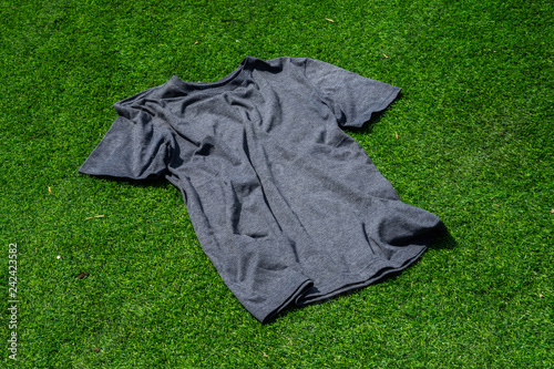 The dark blue t-shirt on the green grass.