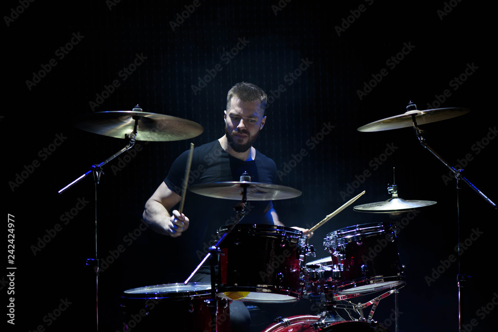 music, people, musical instruments and entertainment concept - male musician with drumsticks playing drums and cymbals at concert or studio music, people, musical instruments and entertainment concept - male musician with drumsticks playing drums and cymbals at concert or studio