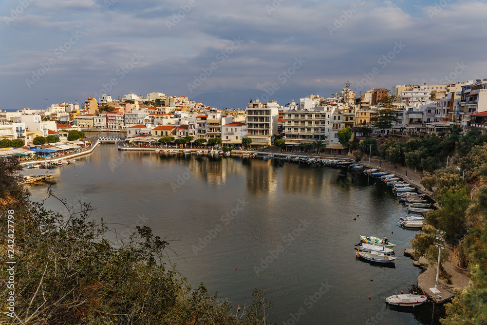 top view of the bay with small white boats and the Greek city of Agios Nikolaos