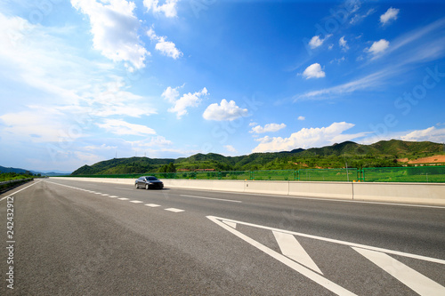 Highway, under the background of blue sky and white clouds