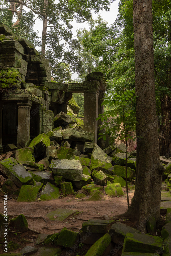 Fallen rocks by stone doorway in trees Fallen rocks by stone doorway in trees