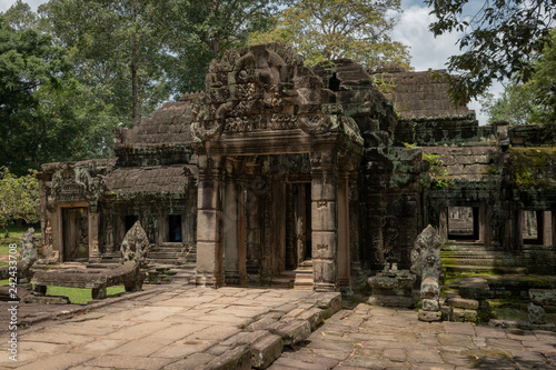 Facade of Banteay Kdei temple in trees