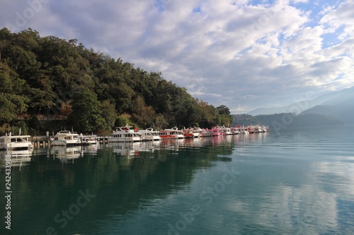 View of Sun Moon Lake with the passenger boats waiting at the numerous piers © khlongwangchao