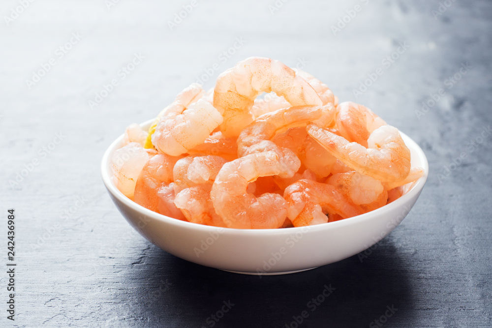 Shrimp with spices and lemon in a bowl close-up. Shrimp with spices and lemon in a bowl close-up.