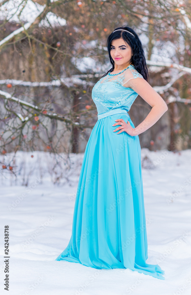 Greece woman in blue long romantic dress at snowy day, femininity and grace concept, winter fairytale Greece woman in blue long romantic dress at snowy day, femininity and grace concept, winter fairytale