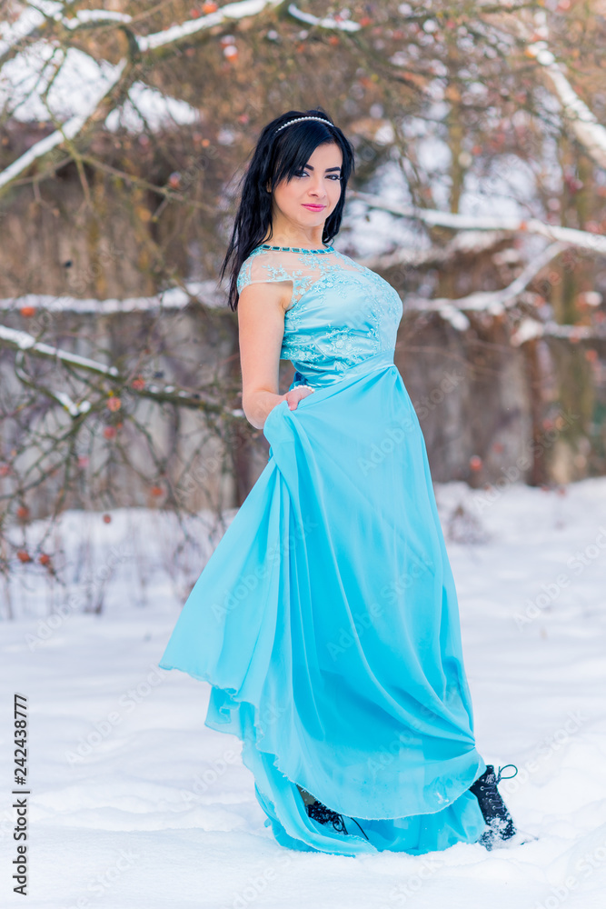 Greece woman in blue long romantic dress at snowy day, femininity and grace concept, winter fairytale Greece woman in blue long romantic dress at snowy day, femininity and grace concept, winter fairytale