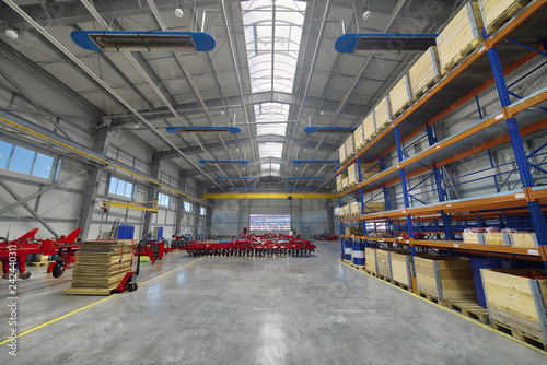 Large, spacious assembly shop. High storage racks with wooden boxes