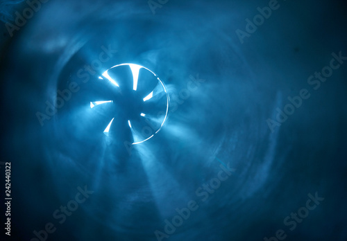Foto Fan illuminated by rays of light in the dark
