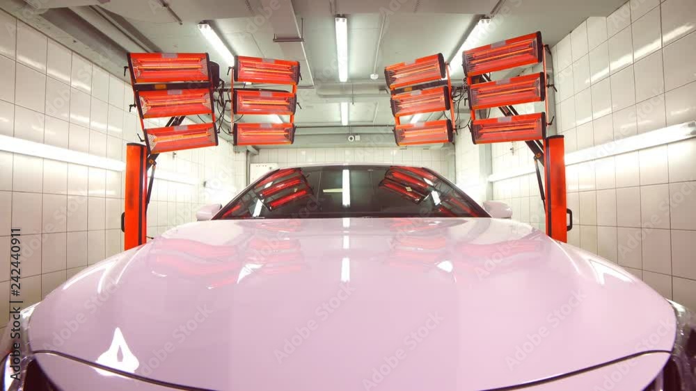 Red warm lamps for curing ceramic polishing standing in back of car