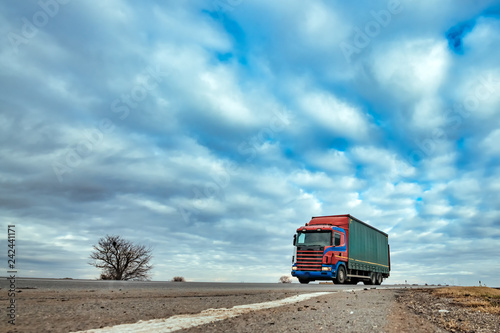Truck on the road through countryside