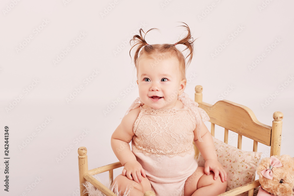 cute baby with flowers on a light background cute baby with flowers on a light background