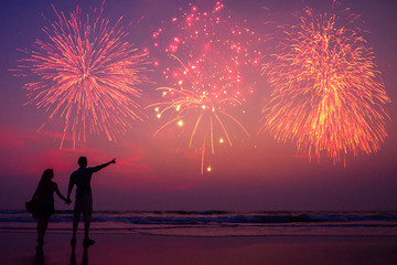 happy couple on the beach enjoying the sunset: concept of independence of america and valentines day