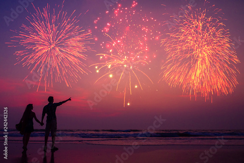 happy couple on the beach enjoying the sunset: concept of independence of america and valentines day