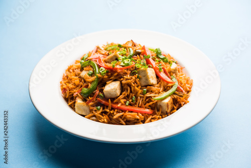 Schezwan paneer fried rice with Szechuan sauce and cottage cheese cubes. served in a bowl or plate or pan. selective focus
