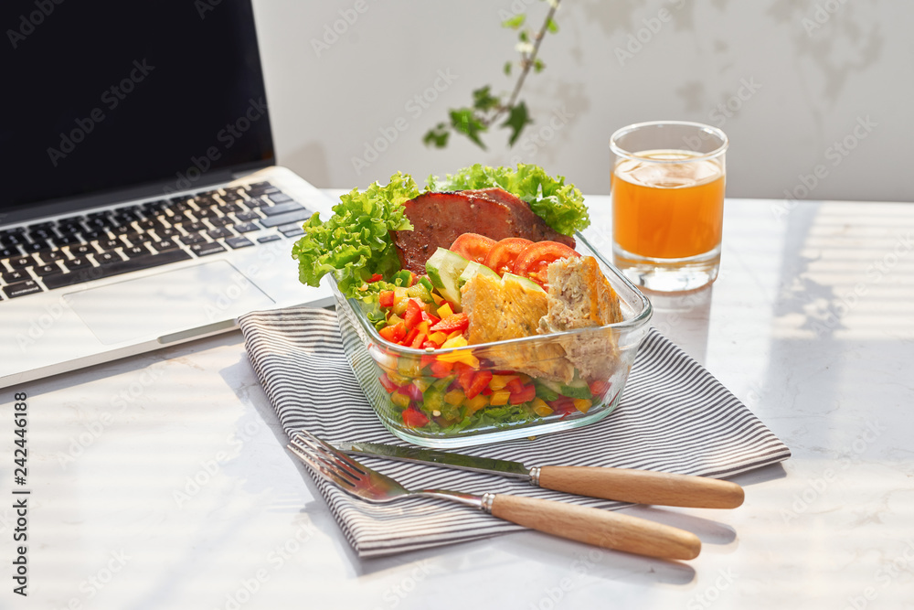 Lunch box on work place of working desk ,Healthy eating clean food habits for diet and health care concept Lunch box on work place of working desk ,Healthy eating clean food habits for diet and health care concept