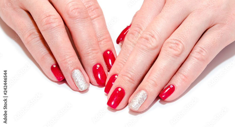 Woman's nails with beautiful red manicure fashion design with gems isolated Woman's nails with beautiful red manicure fashion design with gems isolated