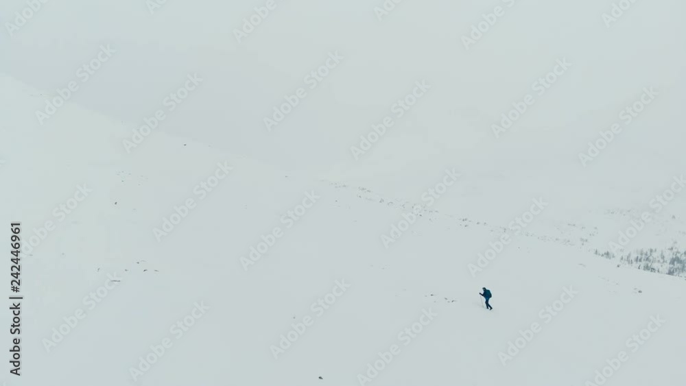 Man with backpack trekking in mountains. Cold weather, snow on hills. Winter hiking. Man with backpack trekking in mountains. Cold weather, snow on hills. Winter hiking.