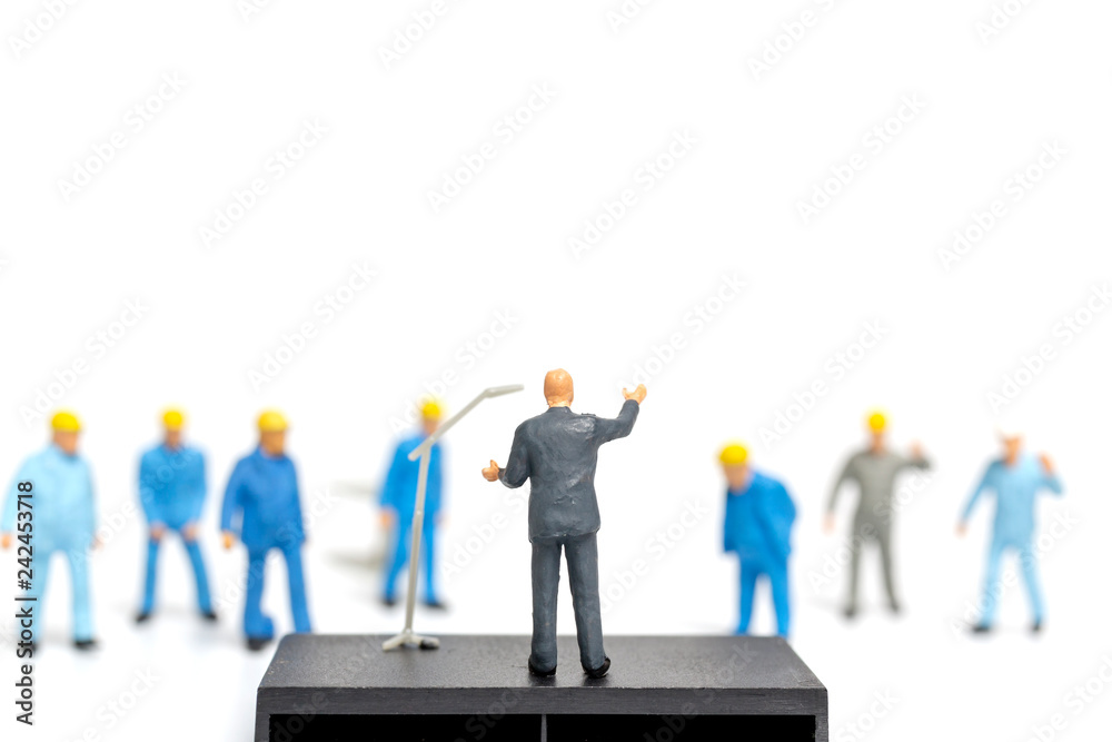 Miniature people : A politician speaking to the people during an election rally 