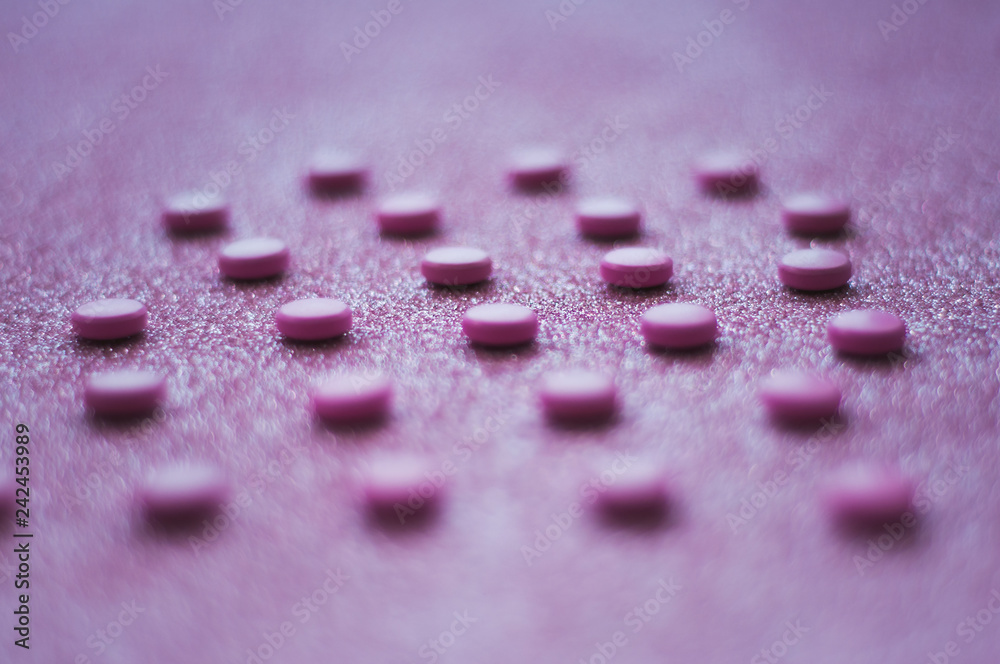 Pink pills, medicine isolated on glittery pink background. Pink pills, medicine isolated on glittery pink background.
