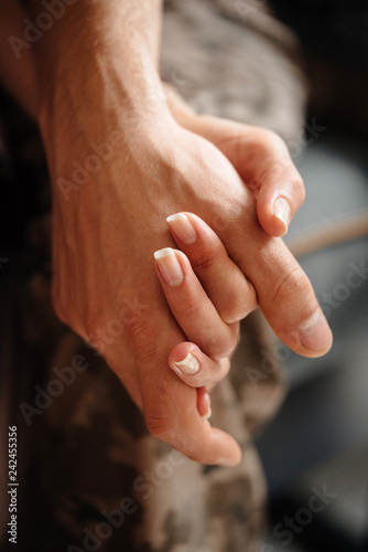 Relationship of love and mutual aid. The concept of friendship and love between a man and a woman. Hand in hand close up.