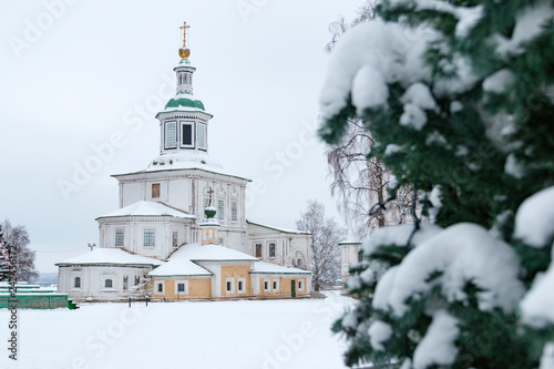 Russian Orthodox Church and Christmas tree in the winter among white snow. Veliky Ustyug, Russia