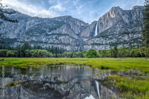 Yosemite Falls and its Reflection on the Water in the Valley